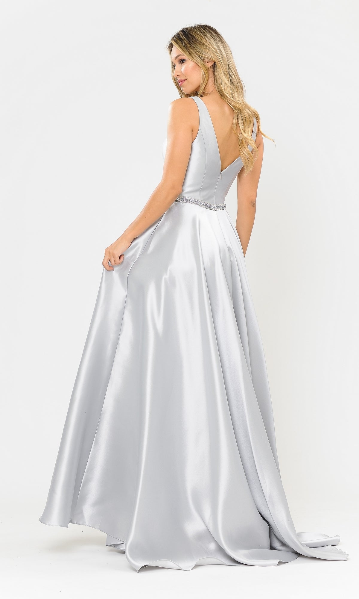 A woman stands gracefully, holding the side of her Deep V-Neck Long Mikado A-Line Prom Dress 8682—a floor-length, sleeveless gown with an open-back design.
